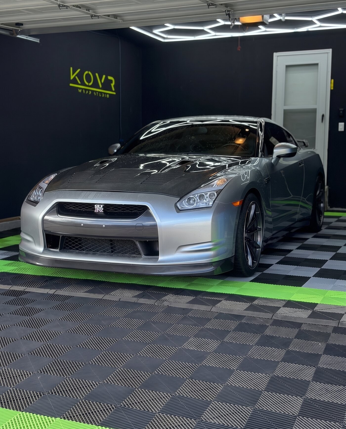 Nissan GT-R in factory silver before the wrap, parked in the KOVR Wrap Studio garage