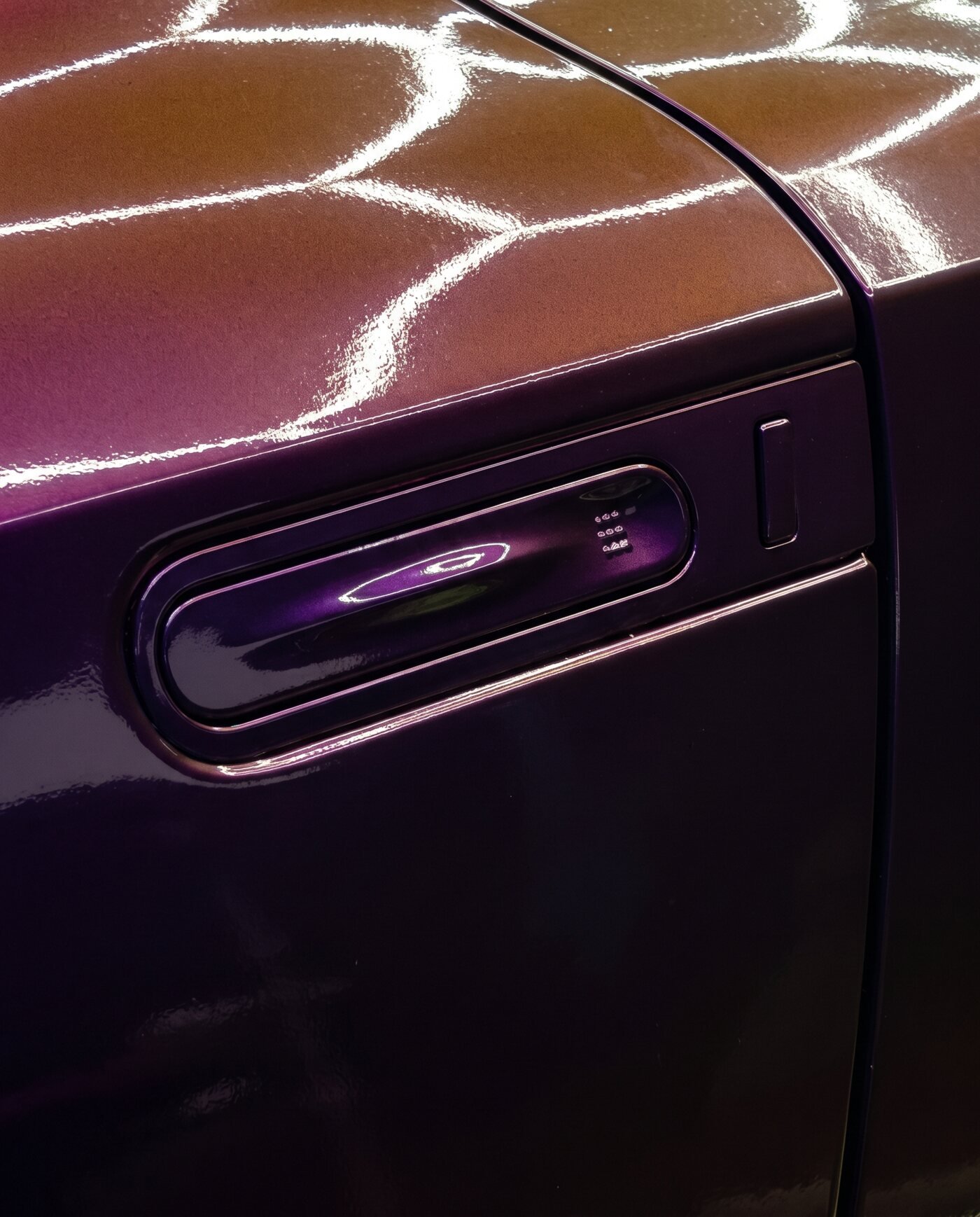 Close-up of Rushing Riptide color-shift finish on the GT-R's door handle