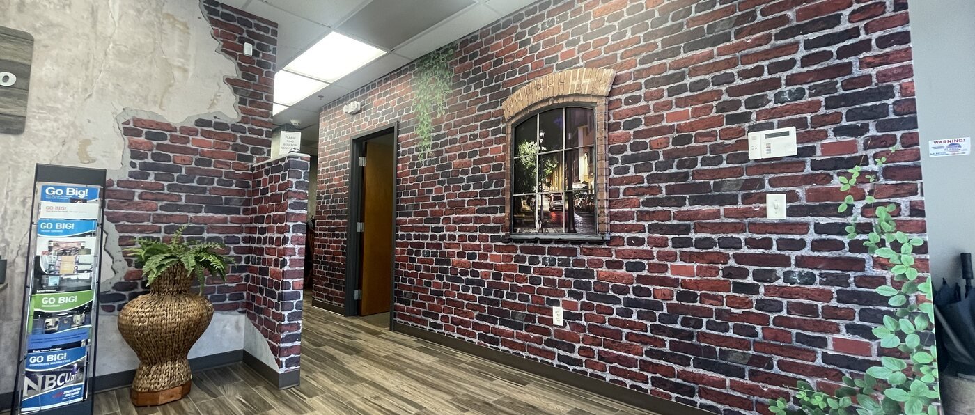 Interior brick wall mural graphic in an office lobby